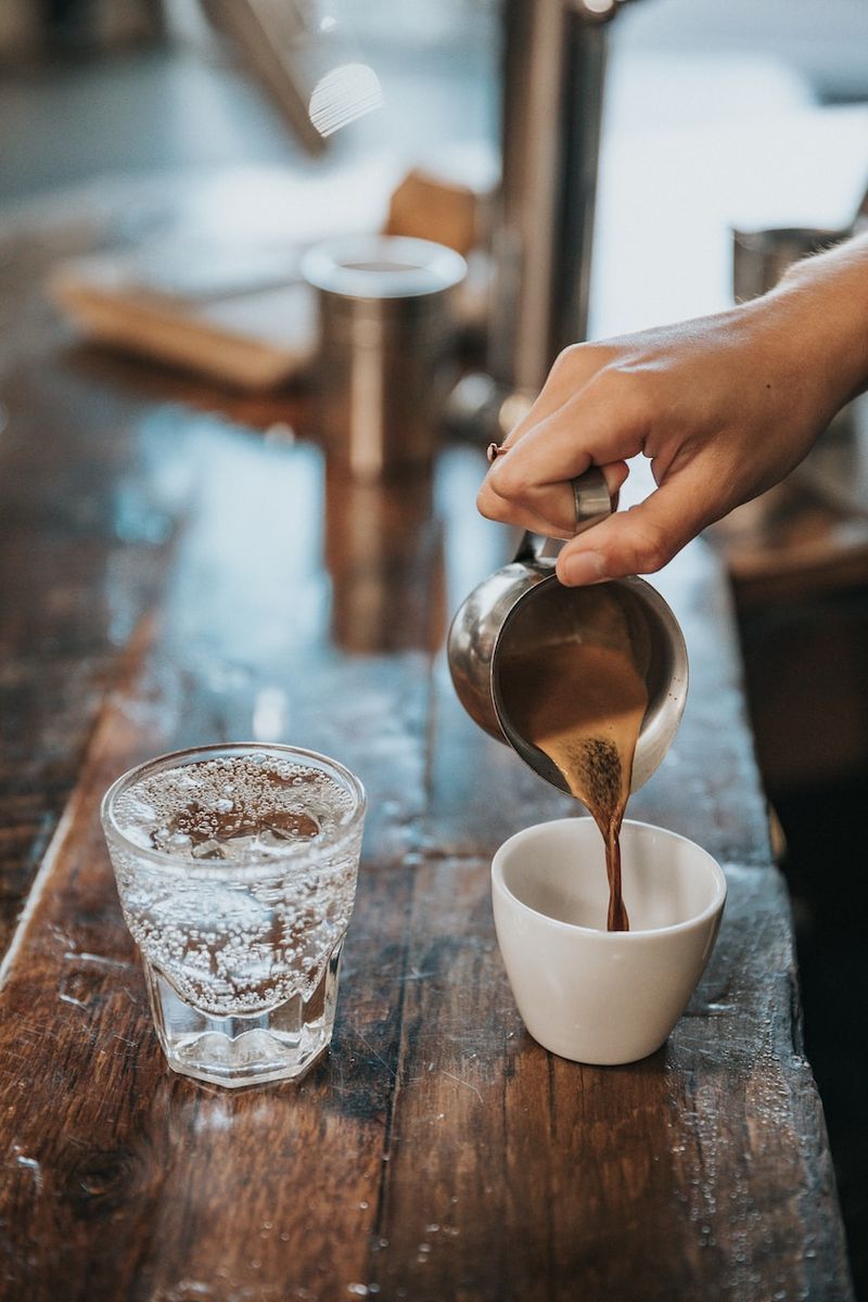 Espresso poured into a cup at the café bar